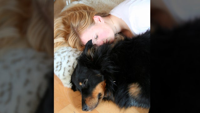 Women sleep better with dogs by their side, study says