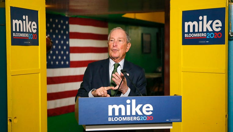 Mike Bloomberg speaks from behind a lecturn