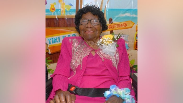 Harlem resident Alelia Murphy, wearing a crown, smiles