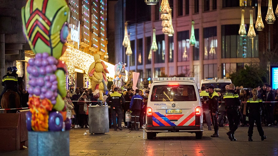 Police officers and a police car on a street in the Hague