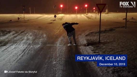 Storm winds toss tourist around icy pavement in Iceland