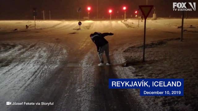 Storm winds toss tourist around icy pavement in Iceland