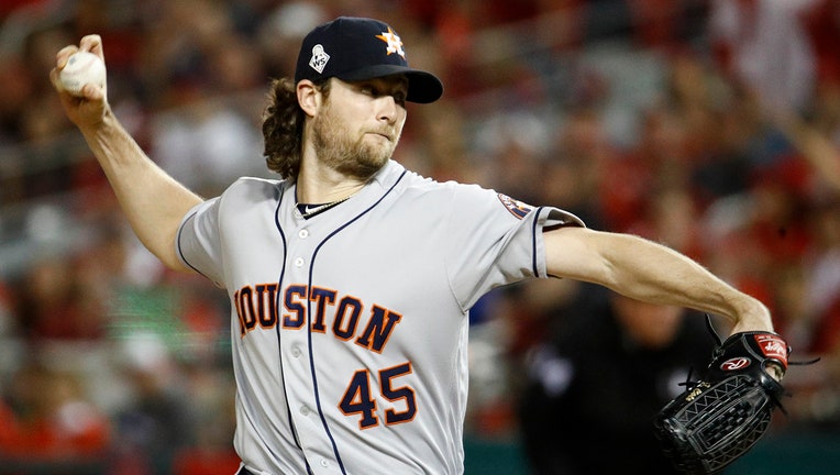 Pitcher Gerrit Cole winds up to pitch