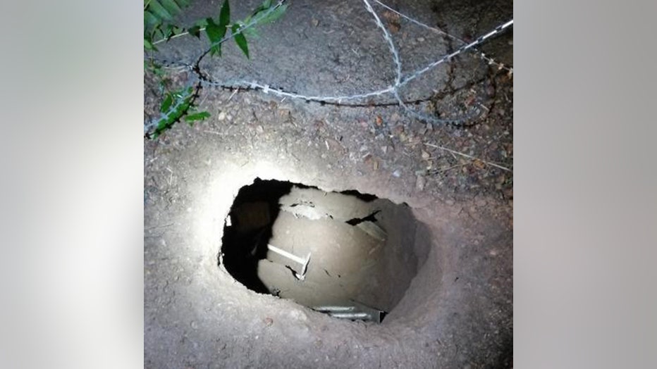 A tunnel dug into the ground near the border