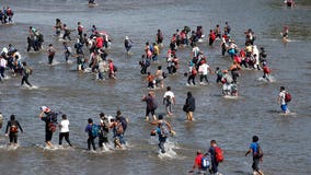 Hundreds of migrants cross river from Guatemala to Mexico