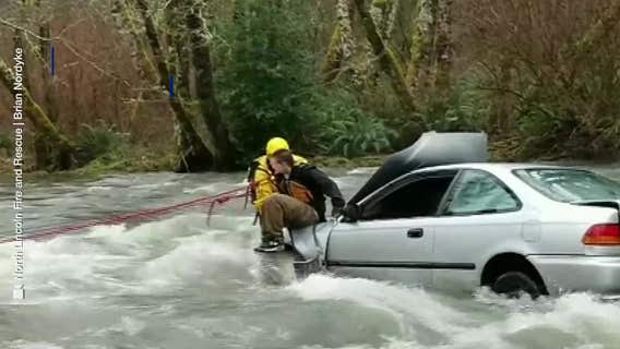 Video: Firefighter rescues driver stranded in raging river
