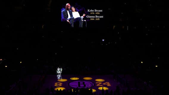 Chairs Bryant and daughter sat on left vacant, with flowers during Nets game