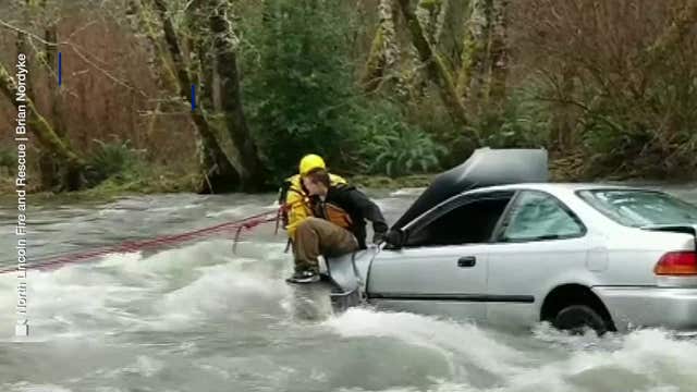 Video: Firefighter rescues driver stranded in raging river
