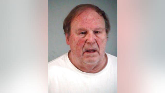 Sandy Hook denier charged with having victim's dad's ID