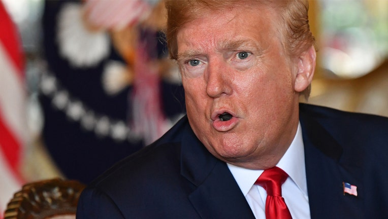 U.S. President Donald Trump answers questions from reporters after making a video call to the troops stationed worldwide at the Mar-a-Lago estate in Palm Beach Florida, on Dec. 24, 2019. (Photo by NICHOLAS KAMM/AFP via Getty Images)