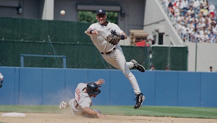 New York Yankees shortstop Derek Jeter throws to first base during a game at Yankee Stadium in New York, July 22, 1998.
