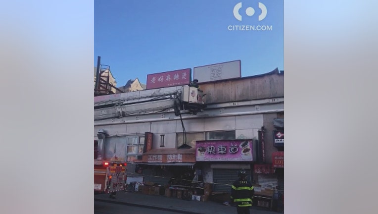 Firefighters examine building facade