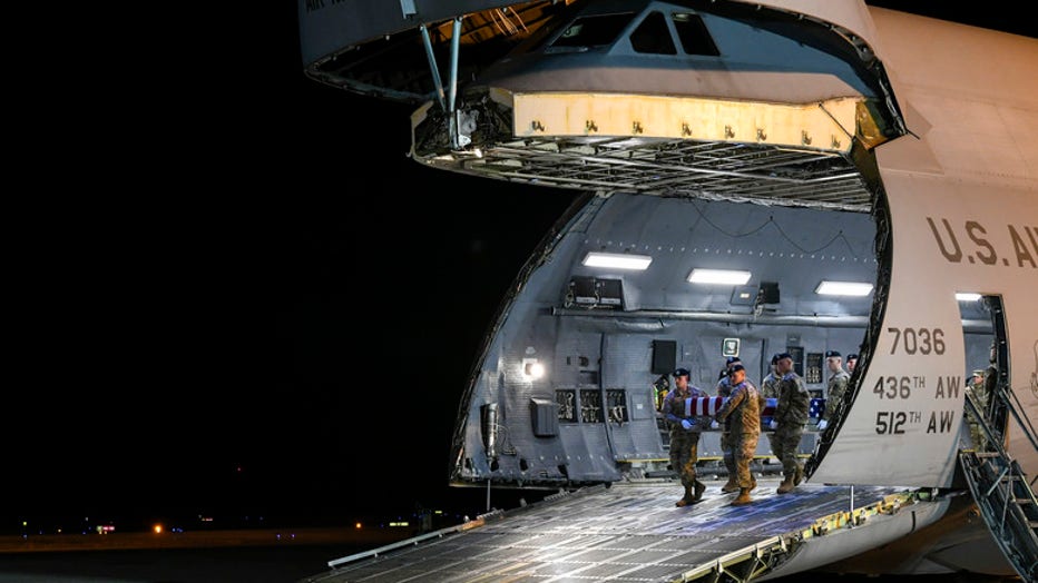 A U.S. Army carry team transfers the remains of Spc Antonio I. Moore, of Wilmington, N.C., Jan. 28, 2020 at Dover Air Force Base, Del. Moore was assigned to the 363rd Engineer Battalion, 411th Engineer Brigade, Knightdale, N.C. (U.S. Air Force Photo by Senior Airman Christopher Quail)