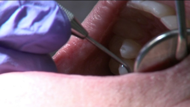 Closeup of dental instruments inside a person's mouth