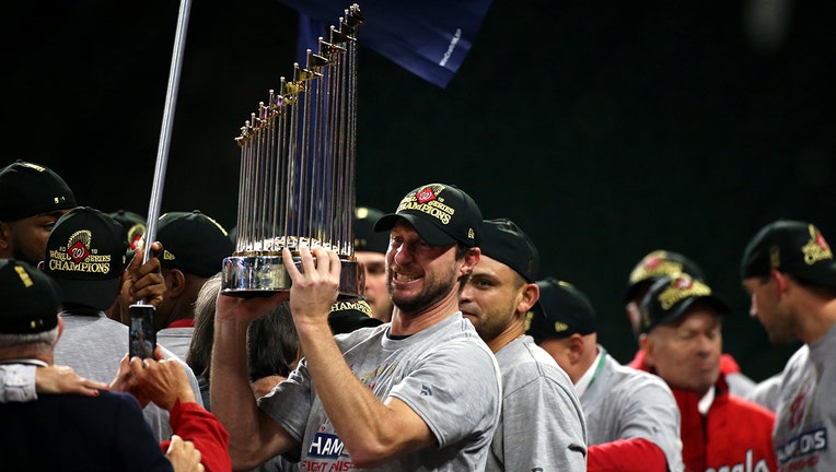 Baseball players and World Series trophy