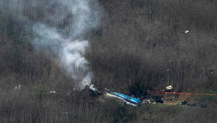 CALABASAS, CALIFORNIA - JANUARY 26: (EDITOR'S NOTE: Alternate crop.) Wreckage of the crashed helicopter that was carrying former NBA star Kobe Bryant and his 13-year-old daughter Gianna smolders on the ground on January 26, 2020 in Calabasas, California. According to reports, five people including Bryant and his daughter have been confirmed killed in the crash. (Photo by David McNew/Getty Images)