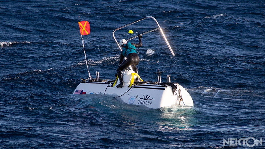 Man removing handrail from submarine