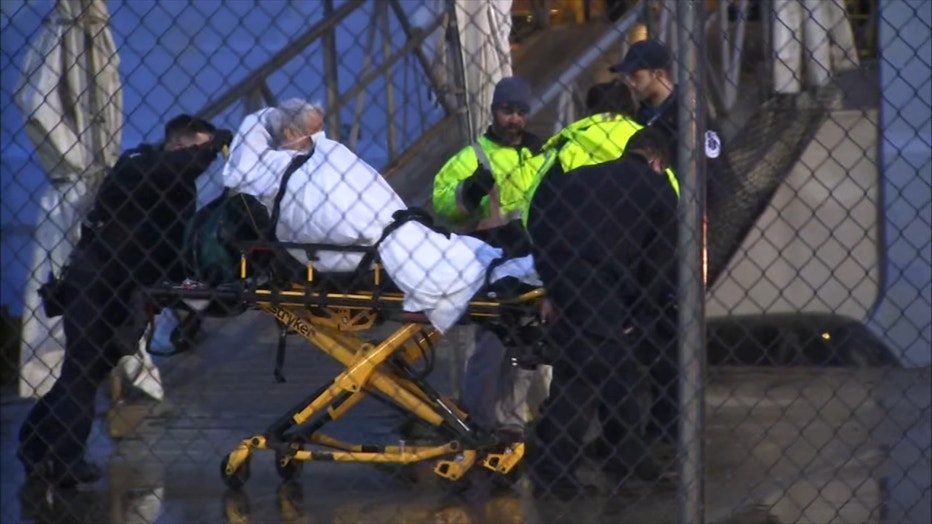 A passenger is taken away from a cruise ship on a stretcher shortly after it docked in New Jersey amid coronavirus fears.