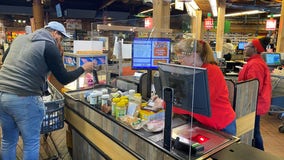 Protective barriers being installed at supermarket registers