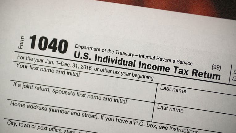 FILE - A copy of a IRS 1040 tax form is seen at an H&R Block office on Dec. 22, 2017 in Miami, Florida.