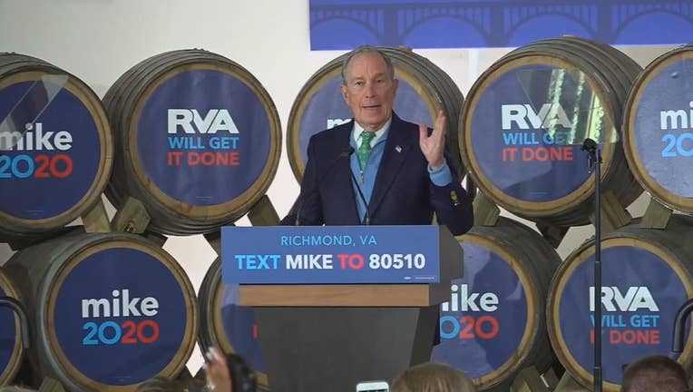 Mike Bloomberg standing at a lectern