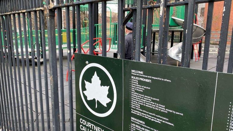 A police officer keeps watch at a shuttered playground in Harlem, March 31, 2020.