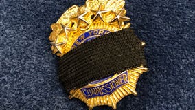 NYPD officers wearing black bands on badges to honor COVID-19 dead