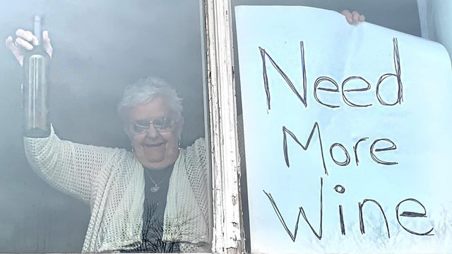 Grandma in quarantine with 'Need More Wine' sign goes viral