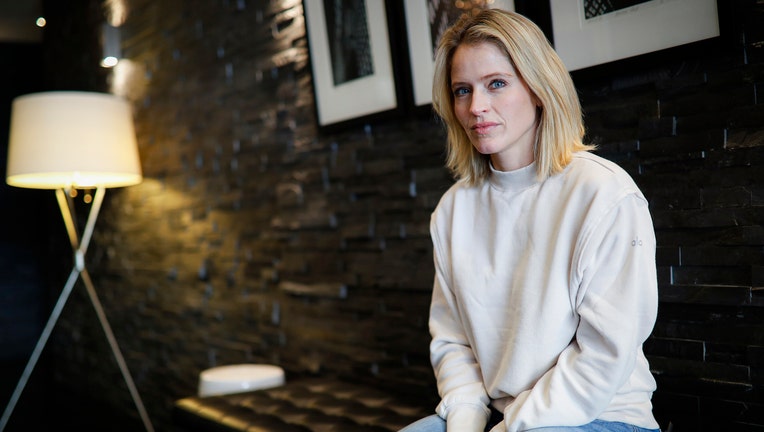 Sara Haines sits on a bench in her lobby
