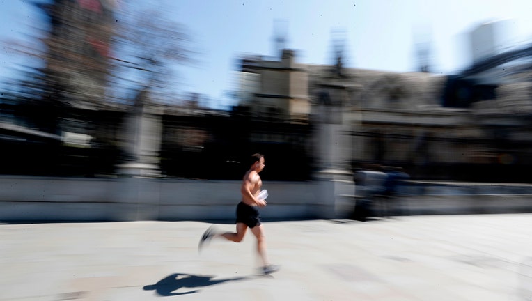 Shirtless jogger runs through London