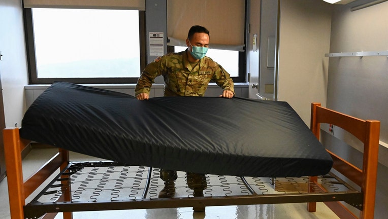 Soldier sets up a bed