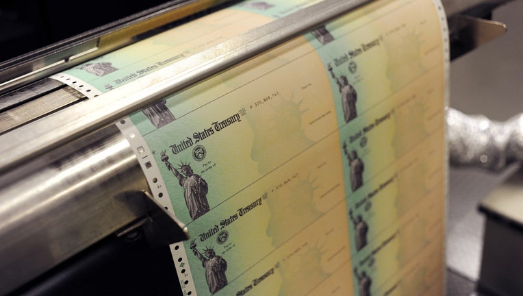 Blank U.S. Treasury checks run through a printer at the U.S. Treasury printing facility.