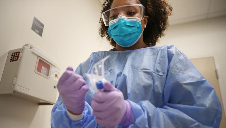 Velocity Urgent Care x-ray technician and medical assistant Britni Chavis prepares to test a patient for the novel coronavirus April 15, 2020 in Woodbridge, Virginia. 