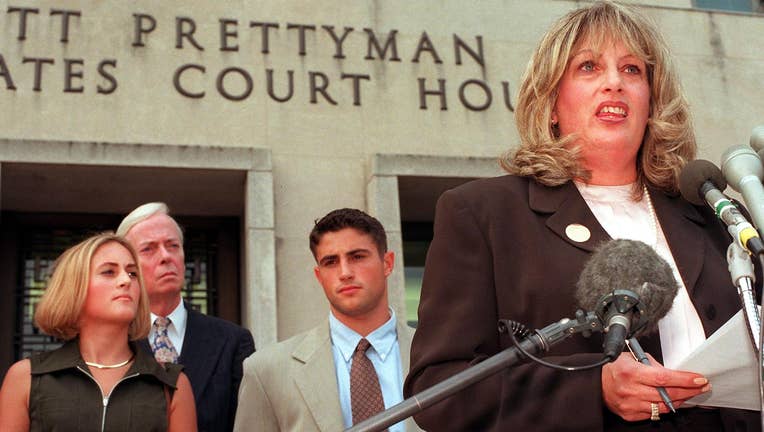 Linda Tripp (R) speaks to the press in front of th