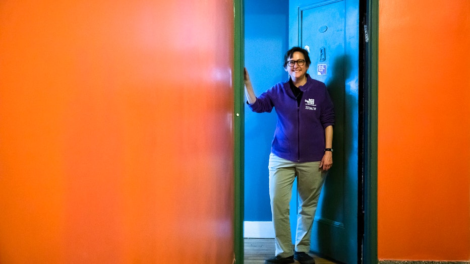 Rabbi Sharon Kleinbaum stands in the doorway of her apartment