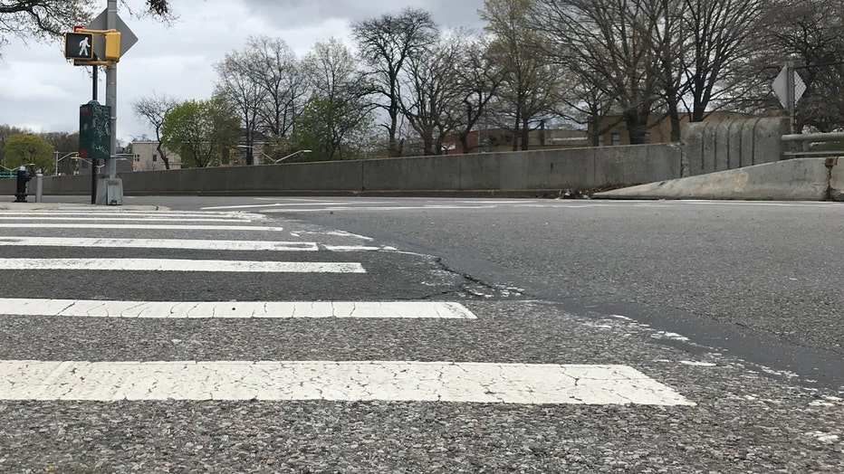 A low-angle view of a crosswalk and road in NYC