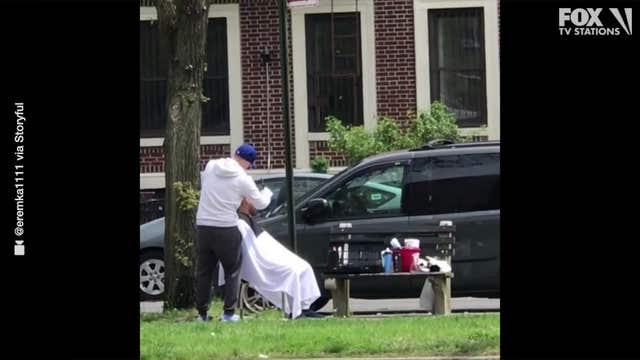 Barber defies lockdown to give haircuts on a Brooklyn sidewalk