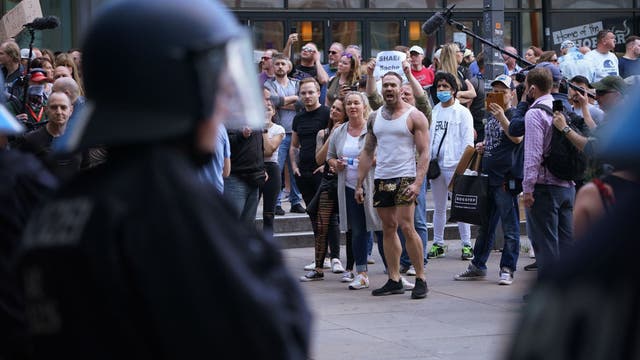 New virus clusters show risks of 2nd wave as protests flare