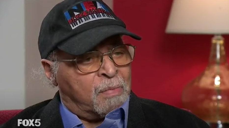 Jazz musician Jimmy Cobb wearing a cap and eyeglasses