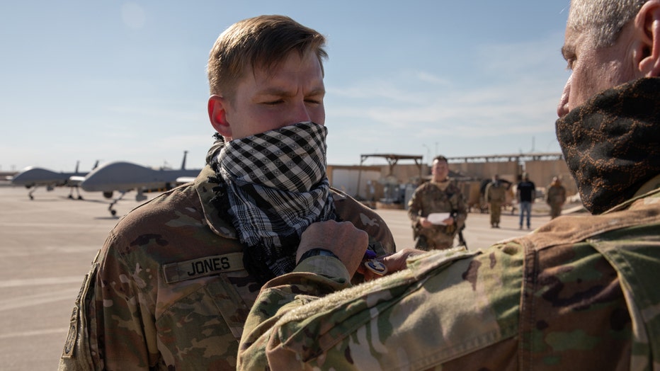 An officer pins a medal on a soldier