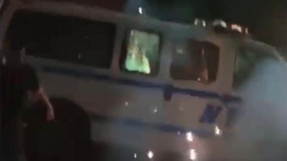 NYPD hunts for suspects seen setting police vehicle on fire