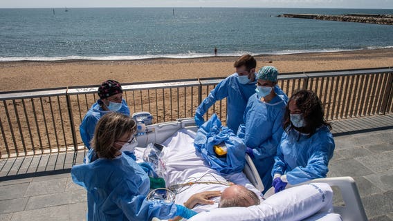 Hospital staff in Spain wheels recovering coronavirus patients to the beach