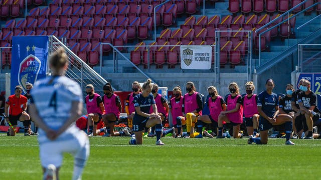 NWSL players kneel during the national anthem