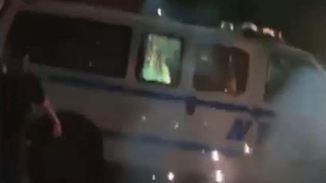 NYPD hunts for suspects seen setting police vehicle on fire