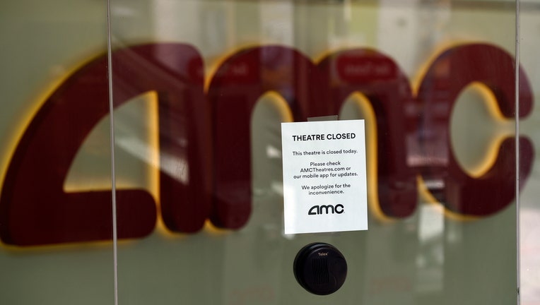 Sign on a glass door to an AMC movie theater