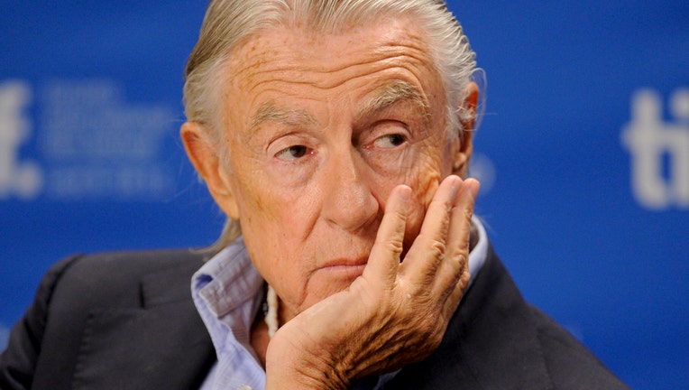 Joel Schumacher resting his chin in his hand