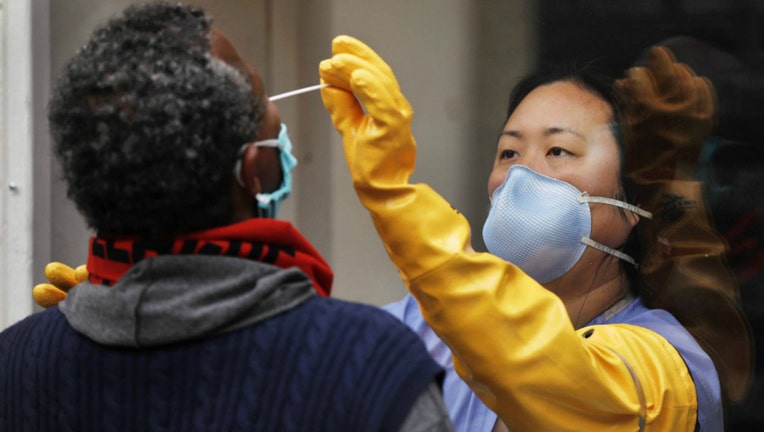 A nurse practitioner takes a swab sample testing for Coronavirus Covid-19.