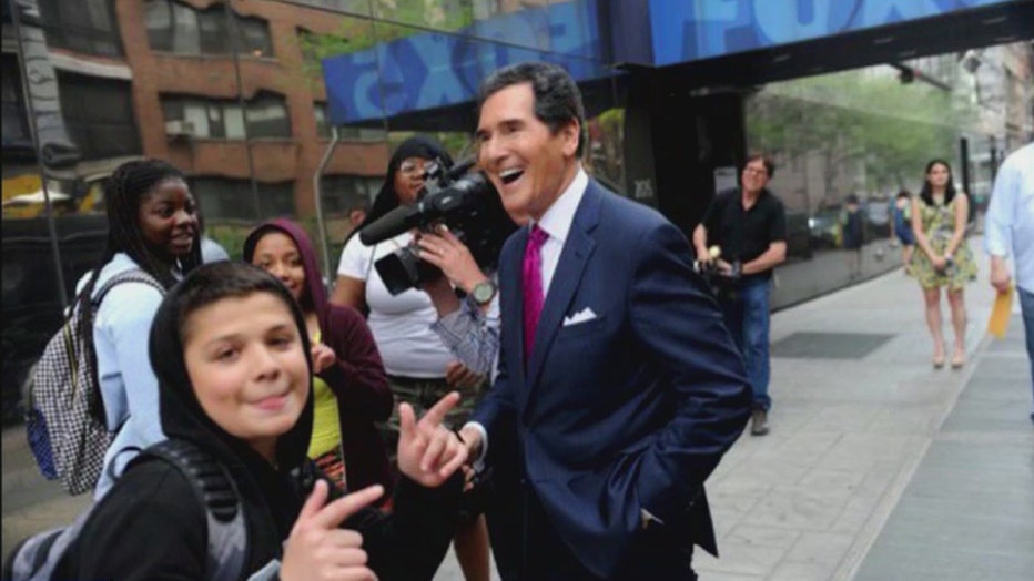 Ernie Anastos and some kids outside the station