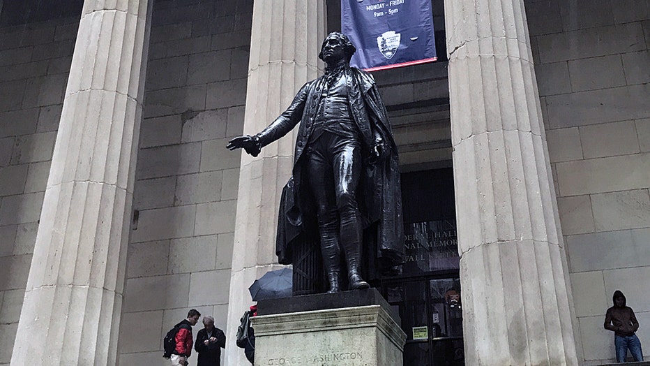 George Washington statue on a pedestal in front of a building with columns