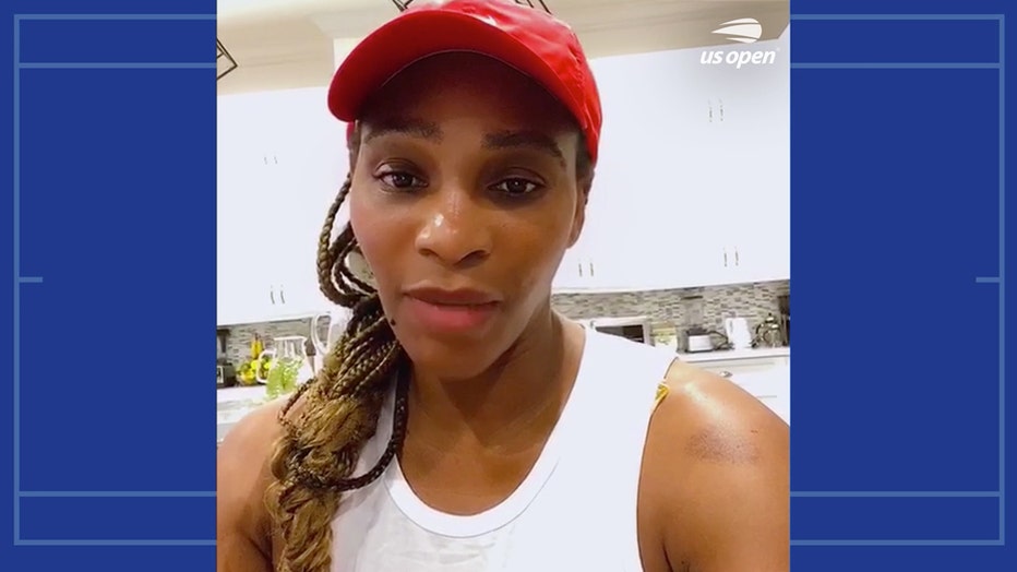 Serena Williams wearing a red hat and a white tank top